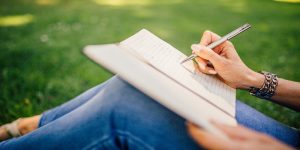 A woman noting things on her notebook