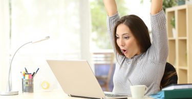 A woman celebrating after solving probate puzzles of heirship verification