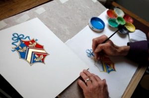 A herald painter sketching the coat of arms